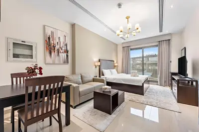 a living room with a couch and a table at Full burj Khalifa view chic Studio in Dubai