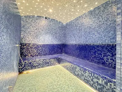 a blue tiled bathroom with a tub in a room at GuestReady - 1BR l Canal View in Business Bay in Dubai