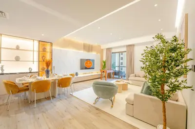 a living room with a table and chairs and a couch at EasyGo - Luxury 3BR with Maid's Room, Dubai Eye View, JBR in Dubai