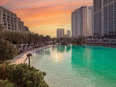 a large swimming pool in a city with tall buildings at GuestReady - 1BR | Creek Beach Getaway in Dubai