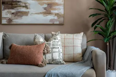 a gray couch with pillows in a living room at GuestReady - 1BR | Creek Beach Getaway in Dubai