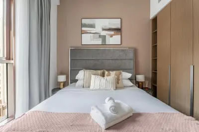 a bedroom with a large bed with white sheets and pillows at GuestReady - 1BR | Creek Beach Getaway in Dubai