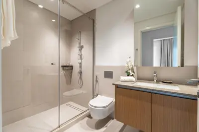 a bathroom with a toilet and a shower and a sink at GuestReady - 1BR | Creek Beach Getaway in Dubai