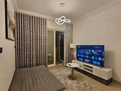 a living room with a large flat screen tv at Marina View Apartment Near JBR Beach & Marina Mall in Dubai