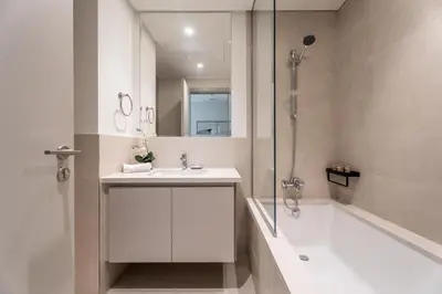 a bathroom with a sink and a shower and a tub at GuestReady - 1BR | Serene Home in Creek Harbour in Dubai