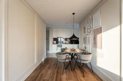 a kitchen and dining room with a table and chairs at GuestReady - 1BR | High-Floor Skyline Elegance in Dubai