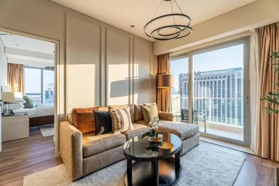 a living room with a couch and a table at GuestReady - 1BR | High-Floor Skyline Elegance in Dubai
