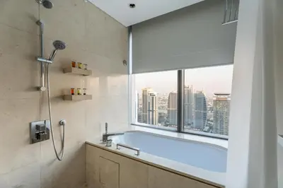 a bathroom with a bath tub and a window at GuestReady - 1BR | High-Floor Skyline Elegance in Dubai