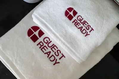 a white napkin with red writing on it at GuestReady - 1BR | High-Floor Skyline Elegance in Dubai