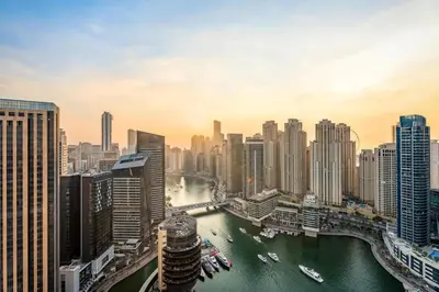 a city skyline with a river and buildings at GuestReady - 1BR | High-Floor Skyline Elegance in Dubai