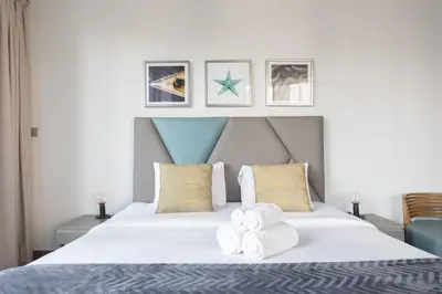 a bedroom with a bed with towels on it at Modern Studio with Balcony Orra, Harbour, Marina in Dubai