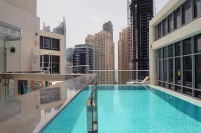 a swimming pool on the roof of a building at Modern Studio with Balcony Orra, Harbour, Marina in Dubai