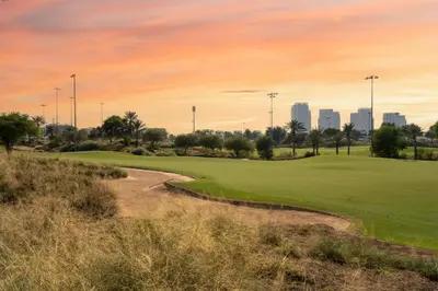 a golf course with the city in the background at GuestReady - Private 4BR Villa | Golf Course View in Dubai