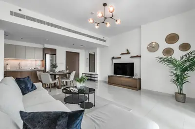 a living room with a white couch and a table at 1BR at Beach Isle Tower Emaar Beach front by EE Holiday Homes in Dubai