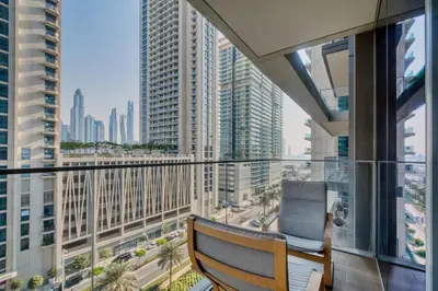 a balcony with a bench and a view of a city at 1BR at Beach Isle Tower Emaar Beach front by EE Holiday Homes in Dubai