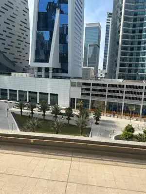 a building with palm trees in front of a city at Unique 1 bed apart in Business Bay close to downtown in Dubai