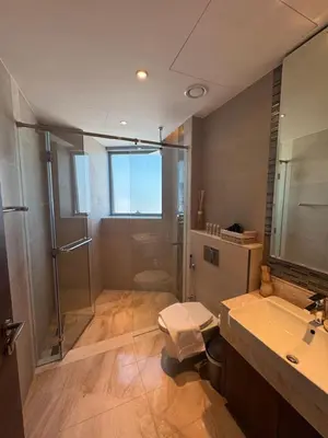 a bathroom with a shower and a sink and a toilet at Mahogany 22 - 4BR 16PAX - Burj Khalifa View Central in Dubai