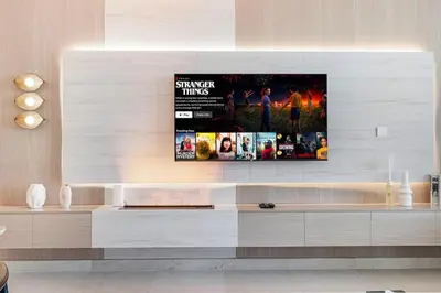 a living room with a tv on a wall at Mahogany 22 - 4BR 16PAX - Burj Khalifa View Central in Dubai