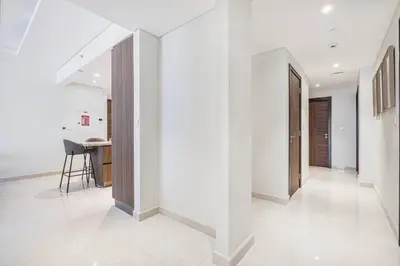 a hallway of a house with white walls and white floors at Mahogany 22 - 4BR 16PAX - Burj Khalifa View Central in Dubai