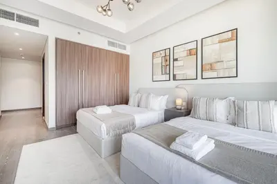 a bedroom with two beds and a couch at Mahogany 22 - 4BR 16PAX - Burj Khalifa View Central in Dubai