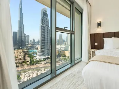 a bedroom with a large window with a view of the city at New-Best Burj Khalifa View I 2BR I Walk DubaiMall in Dubai