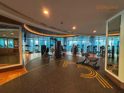 a gym with exercise equipment in a building at 3BR Skyline Burj Panorama with Infinity Pool Vibes in Dubai
