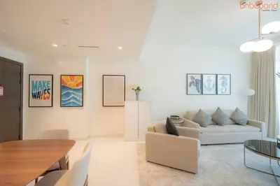a living room with a couch and a table at Beach vibes with Serene views in Dubai