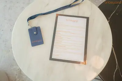 a white plate with a piece of paper on a table at Beach vibes with Serene views in Dubai