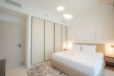 a white bedroom with a large white bed in it at Beach vibes with Serene views in Dubai