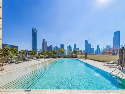 a swimming pool with a city skyline in the background at Full Burj Khalifa & Fountain Views - Luxury 2BR in Downtown Dubai in Dubai