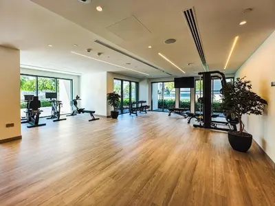 an empty gym with a hard wood floor and windows at Full Burj Khalifa & Fountain Views - Luxury 2BR in Downtown Dubai in Dubai