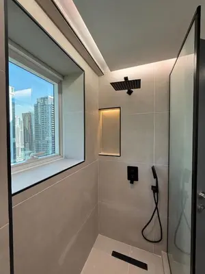 a bathroom with a shower with a window at ZenStay - Charming Studio in JLT, near JBR &Marina in Dubai