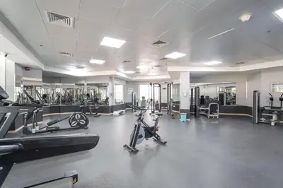 a gym with exercise bikes and machines in a room at ZenStay - Charming Studio in JLT, near JBR &Marina in Dubai