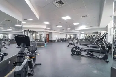 a gym with several treadmills and cardio machines at ZenStay - Charming Studio in JLT, near JBR &Marina in Dubai