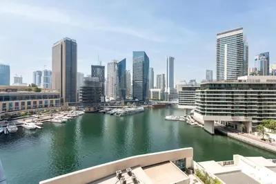 a view of a river with boats in a city at Gala Guests - Luxury Dubai Marina View Apartments - 1 min Walk to Tram in Dubai