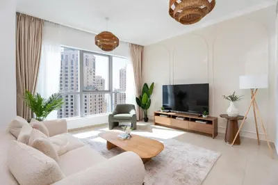 a living room with a couch and a tv at Gala Guests - Luxury Dubai Marina View Apartments - 1 min Walk to Tram in Dubai