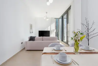 a living room with a table and a couch at Gala Guests - LIV Contemporary Marina View Apartment Collection in Dubai