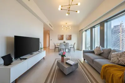 a living room with a large flat screen tv at Burj Royale Luxury 3BR Apartment in Dubai