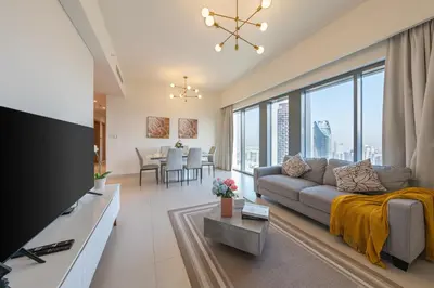 a living room with a couch and a large window at Burj Royale Luxury 3BR Apartment in Dubai