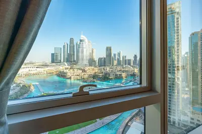 a window with a view of a city at 1BR with Full burj khalifa and fountain view in Dubai