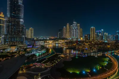 a view of a city at night at 1BR with Full burj khalifa and fountain view in Dubai