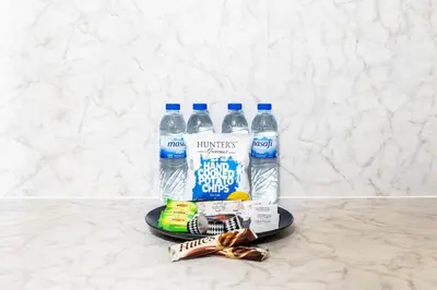 a plate with two bottles of water and some snacks at South Ridge By Luxe Living - Full Burj Khalifa View in Dubai