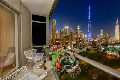 a balcony with a view of a city at night at South Ridge By Luxe Living - Full Burj Khalifa View in Dubai