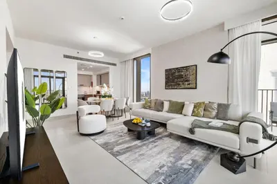 a living room with a couch and a table at BLVD-Manhattan Vibes 4BR High Floor Creek in Dubai