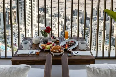 a table with food on it with a view of a city at BLVD-Manhattan Vibes 4BR High Floor Creek in Dubai