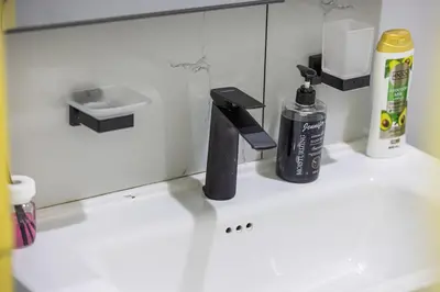 a bathroom counter with a sink and a mirror at Luxury 3 BHK in Dubai Marina DEC 1402 T2 in Dubai