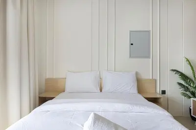 a white bed with white sheets and pillows at Luxury 3 BHK in Dubai Marina DEC 1402 T2 in Dubai
