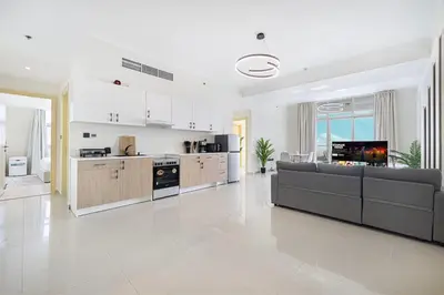 a large living room with a couch and a kitchen at Luxury 3 BHK in Dubai Marina DEC 1402 T2 in Dubai