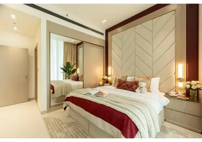 a bedroom with a large bed with a teddy bear on it at Premium 1BR Suite at Binghatti Royale with City Views in Dubai