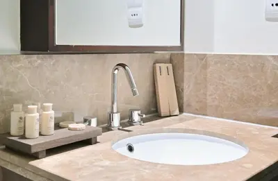a bathroom counter with a sink and a faucet at Luxury 1BR, Long Stays & Walk to Burj Khalifa, High Speed Internet in Dubai